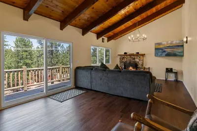 a living room with a couch and a fireplace at Bare Necessities - Comes with a hot tub and a pool table in Big Bear Lake