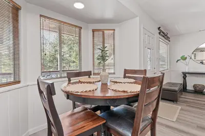 a dining room with a table and chairs at Serenity Knoll - Comfortable, spacious single-level cabin! Newly remodeled! Hot Tub and Pool Table! in Big Bear Lake