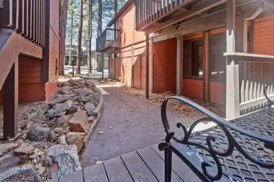 a bench sitting in front of a building at Ski-In Ski-Out Summit Townhouse- Perfect mountain getaway with views of the forest and Snow Summit! in Big Bear Lake