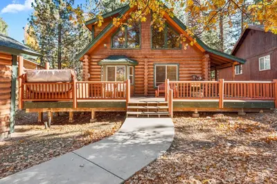 a log cabin with a porch and a deck at Papa Bear's Hideout - Dream Getaway with Hot Tub and Game Room! in Big Bear Lake