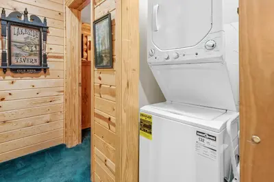a washer and dryer in a tiny house at Papa Bear's Hideout - Dream Getaway with Hot Tub and Game Room! in Big Bear Lake