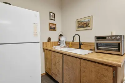 a kitchen with a sink and a microwave at North Shore Lakefront - Spacious Lakefront with Hot Tub, & Game Room in Fawnskin