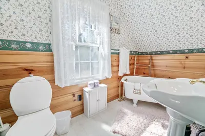 a bathroom with a toilet and a tub and a sink at Oak Nesting - Great chalet style cabin at the end of the street with rustic stone gas log fireplace! in Big Bear Lake