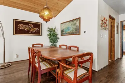 a dining room with a wooden table and chairs at Nightcap Lodge- HOT TUB WITH BREATHTAKING MOUNTAIN VIEWS! in Fawnskin