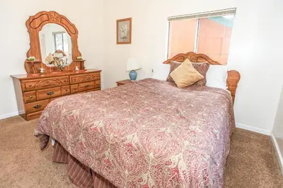 a bedroom with a bed and a dresser and a mirror at Mountain Fever - Offers a Foosball Table and Barbecue Grill and a large back deck! in Big Bear Lake