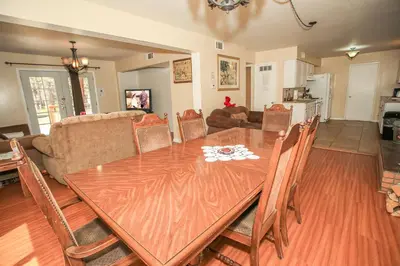 a dining room with a wooden table and chairs at Mountain Fever - Offers a Foosball Table and Barbecue Grill and a large back deck! in Big Bear Lake