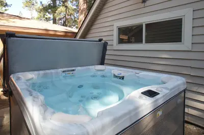 a hot tub in the backyard of a house at Boulder Bay Bungalow - Updated mountain retreat with hot tub, game table, and sauna! in Big Bear Lake