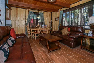 a living room with leather couches and a table at Bear 'n Tree - Cozy cabin near the Village in Big Bear Lake