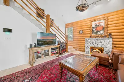 a living room with a tv and a fireplace at Bear Bait - Lots of games, televisions, beds, telescope, and 3 bathrooms in Big Bear Lake