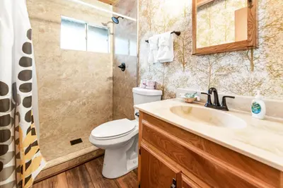 a bathroom with a toilet and a sink and a shower at Bear Crossing - Walk to Snow Summit! Visit this charming mountain home compete with foosball table in Big Bear Lake