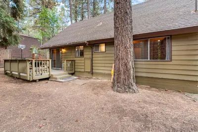 a house with a tree in front of it at Bear Crossing - Walk to Snow Summit! Visit this charming mountain home compete with foosball table in Big Bear Lake