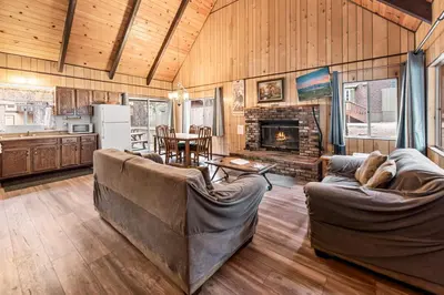 a living room with two couches and a fireplace at Bear Crossing - Walk to Snow Summit! Visit this charming mountain home compete with foosball table in Big Bear Lake