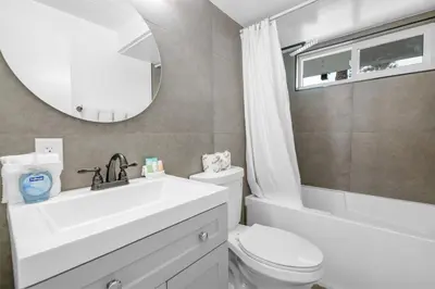a bathroom with a sink and a toilet and a mirror at Big Bear Lake View - By far the best location Big Bear, walk to Lake! in Big Bear Lake