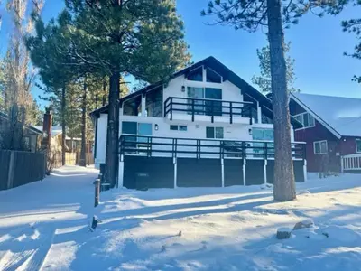 a large white house in the snow with trees at Big Bear Lake View - By far the best location Big Bear, walk to Lake! in Big Bear Lake