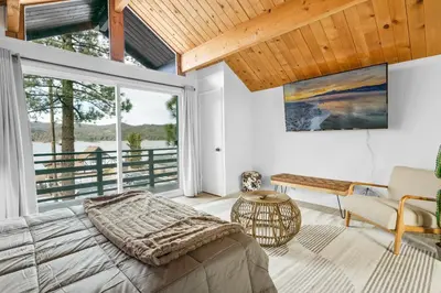 a bedroom with a bed and a large window at Big Bear Lake View - By far the best location Big Bear, walk to Lake! in Big Bear Lake