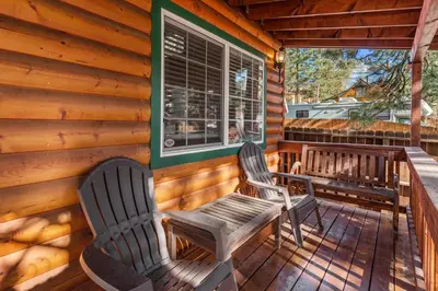 two chairs sitting on the porch of a cabin at Blue Jay Chalet - Classic mountain cabin in one of Big Bear's quietest neighborhoods! in Big Bear Lake