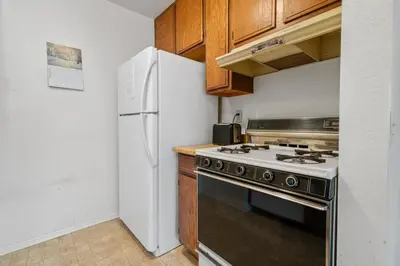 a kitchen with a stove and a refrigerator at Boulder Bay Chalet Condo - Mountain charm condo with lake view and WIFI! in Big Bear Lake