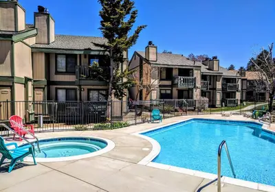 a swimming pool in a courtyard with houses at Boulder Bay Chalet Condo - Mountain charm condo with lake view and WIFI! in Big Bear Lake