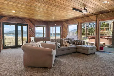 a living room with two couches and a pool table at Grand Lakefront Escape - Gorgeous Lakefront home with Hot Tub and Game Room! in Big Bear Lake