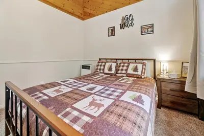 a bedroom with a bed with a quilt on it at Hidden Spot - Desirable Fox Farm area of Big Bear in Big Bear Lake