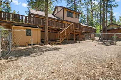 a large house with a deck and a fence at Hidden Spot - Desirable Fox Farm area of Big Bear in Big Bear Lake