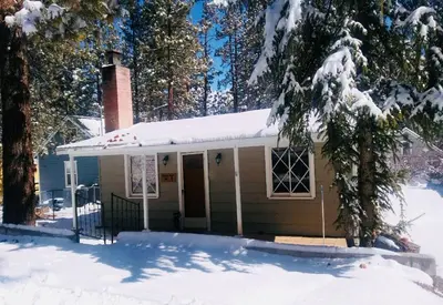 a small house with snow on top of it at Honey Bear - Close to lake and village in Big Bear Lake