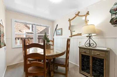 a dining room with a table and chairs and a mirror at Lake Cottage - Vintage Big Bear Cabin close to The Village and Lake in Big Bear Lake