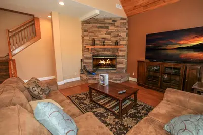 a living room with a couch and a fireplace at Lakeview Court Castle - Short walk to the Village and lake in Big Bear Lake