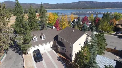 an aerial view of a house with trees and a lake at Lakeview Court Castle - Short walk to the Village and lake in Big Bear Lake