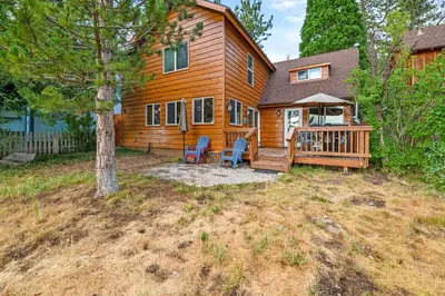 a log home with a porch and a deck at Mallard Landing - Steps from the marina and minutes from the Village in Big Bear Lake