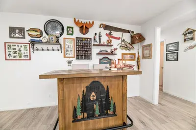 a room with a table with a fireplace in it at Nunu's Cabin - Beautiful cabin, close to ski resorts and town, Hot Tub and Board Games! in Big Bear Lake