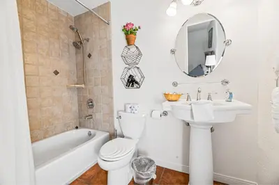 a bathroom with a sink toilet and a mirror at Nunu's Cabin - Beautiful cabin, close to ski resorts and town, Hot Tub and Board Games! in Big Bear Lake