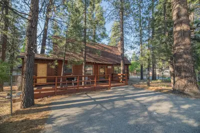 a log cabin in the middle of a forest at Rustic Pine - Rustic true log cabin with plenty of charm, Close to everything! in Big Bear Lake