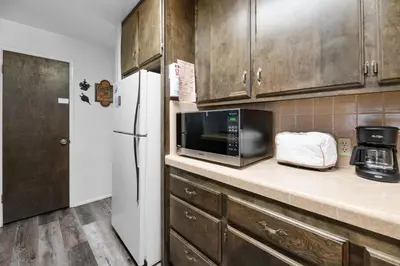 a kitchen with a microwave and a refrigerator at Sky Krest - Located on a quiet street in the middle of town, Games! Pool table! in Big Bear Lake