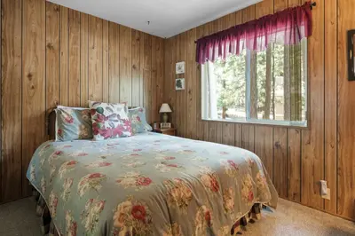 a bedroom with a bed and a window at Sky Krest - Located on a quiet street in the middle of town, Games! Pool table! in Big Bear Lake