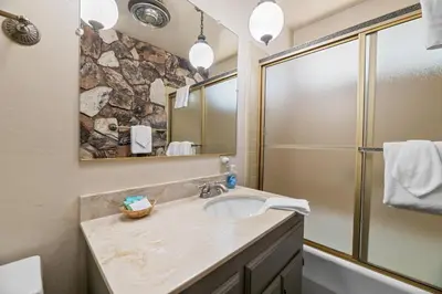 a bathroom with a sink and a shower at Sky Krest - Located on a quiet street in the middle of town, Games! Pool table! in Big Bear Lake