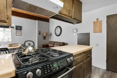 a kitchen with a stove with a tea kettle on it at Sky Krest - Located on a quiet street in the middle of town, Games! Pool table! in Big Bear Lake