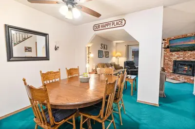 a dining room and living room with a table and chairs at Snow Summit Getaway - Walk to Snow Summit Ski Resort in Big Bear Lake