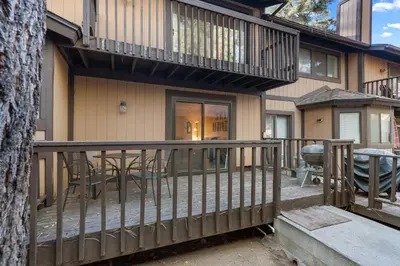 a balcony of a house with tables and chairs at Snow Summit Getaway - Walk to Snow Summit Ski Resort in Big Bear Lake