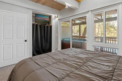 a bedroom with a large bed and windows at Snow Summit Thrush8 - Walk to Snow Summit Ski Resort in Big Bear Lake