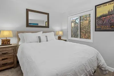 a bedroom with a large white bed and a mirror at Snow Summit Thrush8 - Walk to Snow Summit Ski Resort in Big Bear Lake