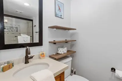 a bathroom with a sink and a mirror and a toilet at Snow Summit Thrush8 - Walk to Snow Summit Ski Resort in Big Bear Lake