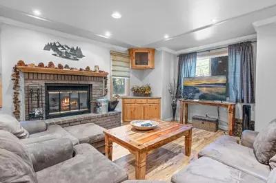 a living room with couches and a fireplace at Summit Condo - Luxury condo, walk to the slopes! in Big Bear Lake