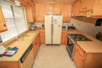 a kitchen with a refrigerator and a sink at Summit Getaway Condo - Affordable and ideally located, Wood burning fireplace! Walk to Ski Resort in Big Bear Lake