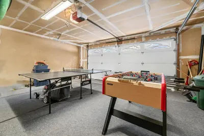 a ping pong table in a room with a ping pong ball at Whiskey Pines Chalet - Warm and cozy cabin with modern features made more fun with a gameroom in Big Bear Lake