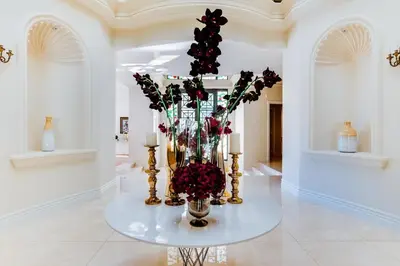 a vase of flowers on a table in a room at Le Jardin in Los Angeles