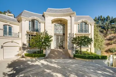 a large white house with a gate and a driveway at Le Jardin in Los Angeles