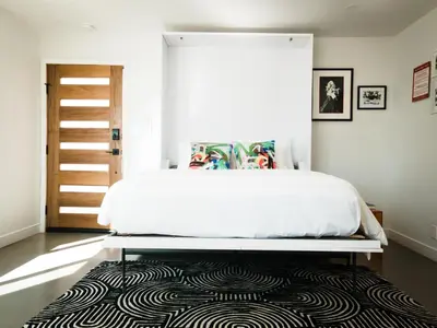 a bedroom with a bed with a black and white rug at The Redline Venice in Los Angeles