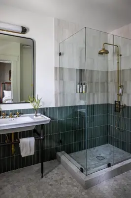 a bathroom with a glass shower and a sink at The Richland in Orange
