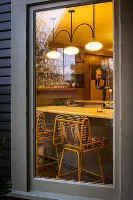 a dining room with a table and chairs through a window at The Richland in Orange
